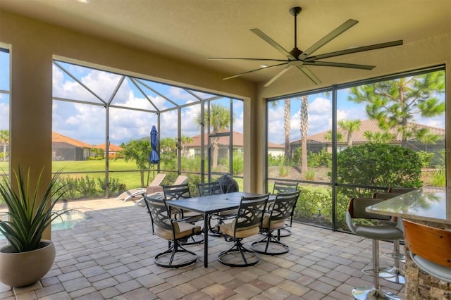 sunroom featuring a wealth of natural light and ceiling fan