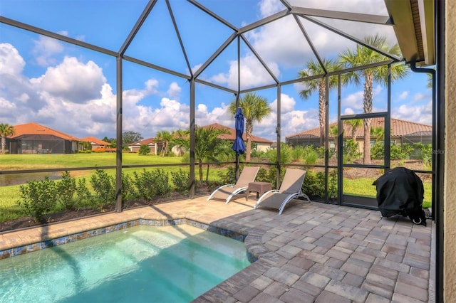 view of pool with area for grilling, a lanai, a patio area, and a jacuzzi