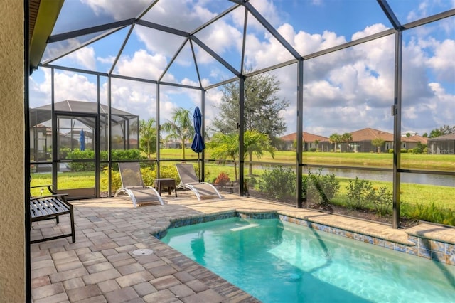 view of swimming pool with a patio area, a water view, and a lanai