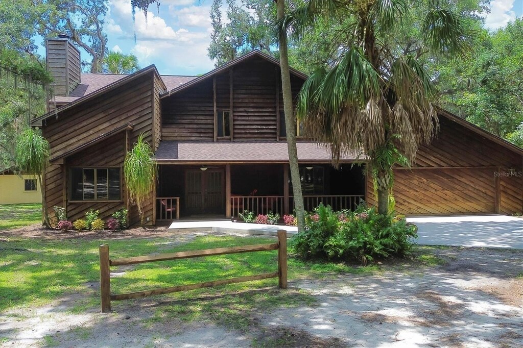 rear view of property featuring a yard