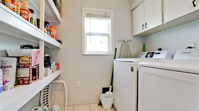 laundry room featuring independent washer and dryer, light tile patterned floors, and cabinets