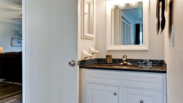 bathroom with vanity and ornamental molding