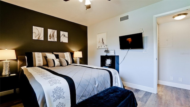 bedroom with ceiling fan and wood-type flooring