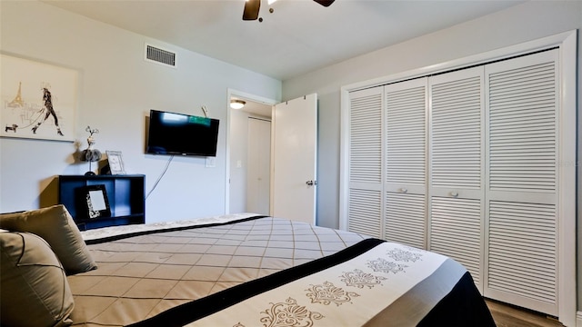 bedroom featuring ceiling fan, light hardwood / wood-style flooring, and a closet