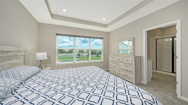 carpeted bedroom featuring a tray ceiling