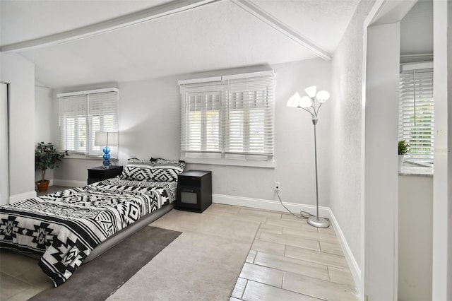 bedroom featuring light colored carpet, lofted ceiling, and multiple windows