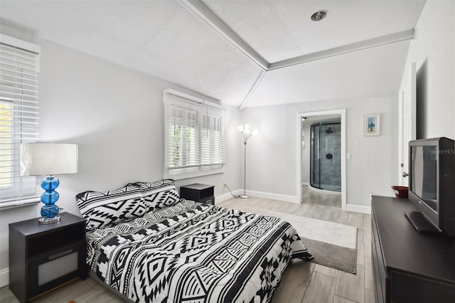 bedroom featuring light hardwood / wood-style flooring and vaulted ceiling