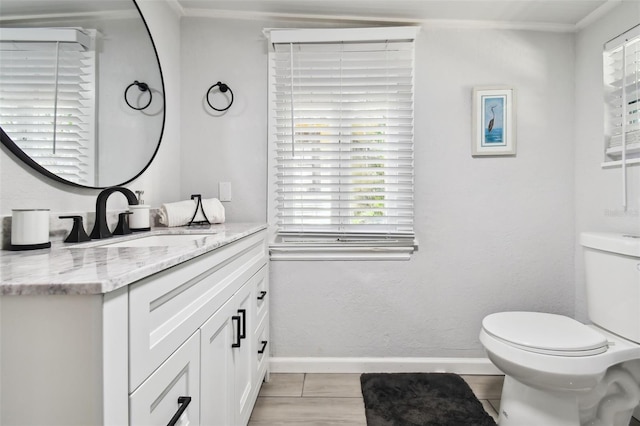 bathroom featuring tile patterned floors, vanity, and toilet