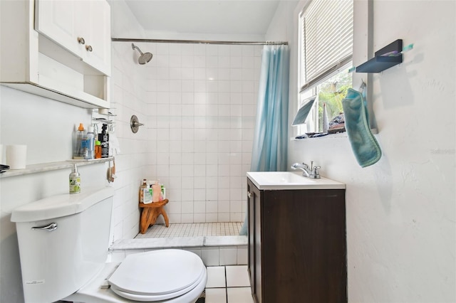 bathroom featuring toilet, tile patterned floors, and vanity