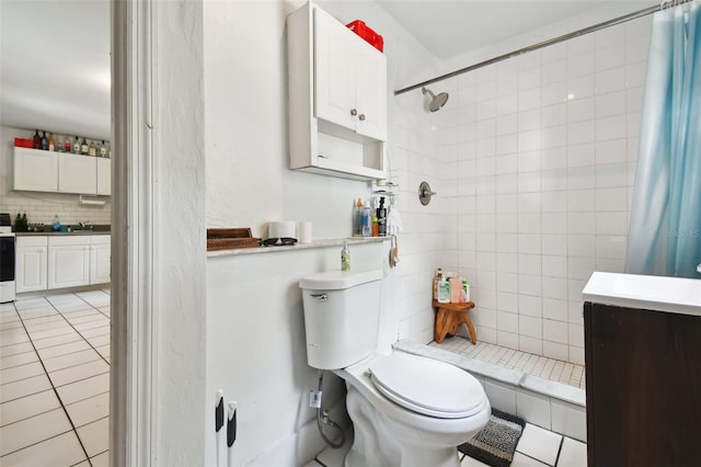 bathroom with a shower with curtain, tile patterned floors, vanity, and toilet