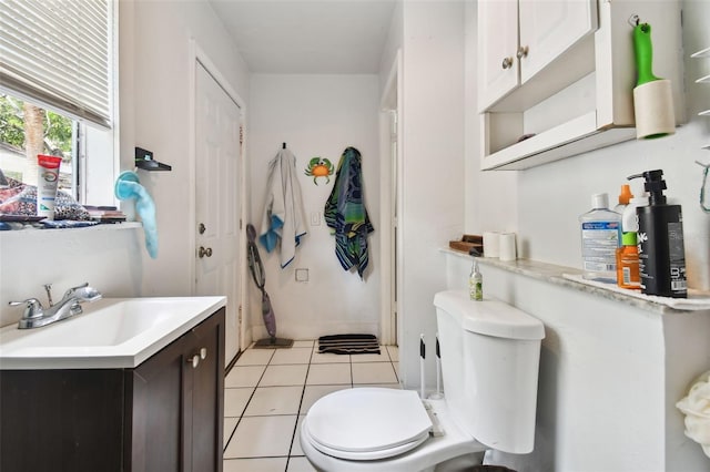 bathroom with tile patterned floors, vanity, and toilet