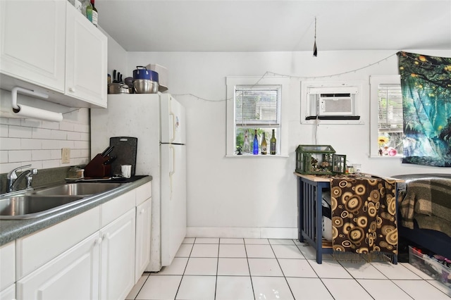 kitchen with white cabinets, sink, tasteful backsplash, and light tile patterned floors