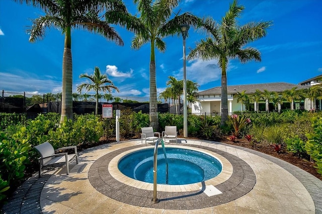 view of pool with a hot tub