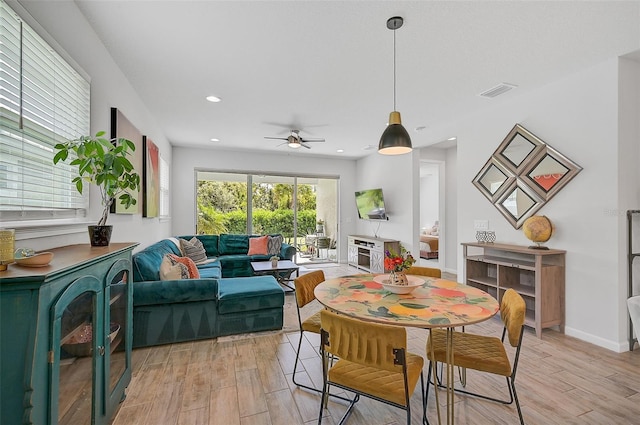 dining room with light wood-type flooring and ceiling fan