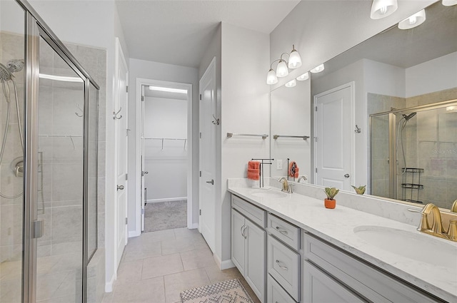 bathroom featuring tile patterned floors, vanity, and an enclosed shower