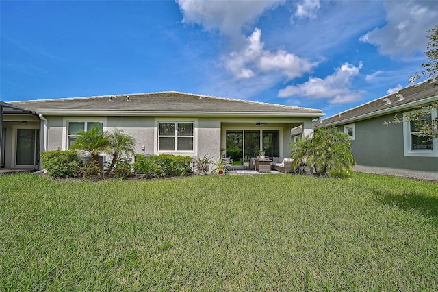 rear view of property featuring a patio area, ceiling fan, and a yard