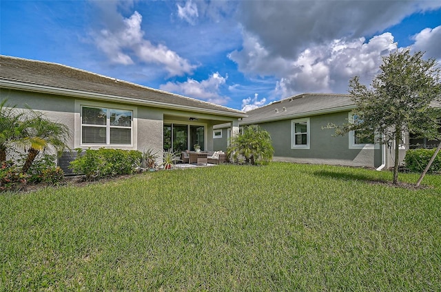 back of house with an outdoor hangout area, ceiling fan, a yard, and a patio