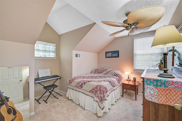 bedroom with a textured ceiling, ceiling fan, lofted ceiling, and light carpet