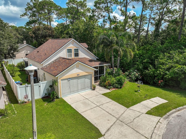 view of front of home with a front lawn and a garage