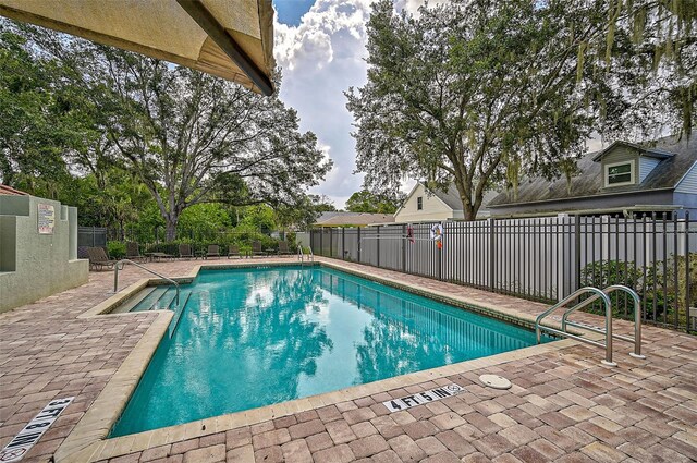 view of swimming pool featuring a patio area