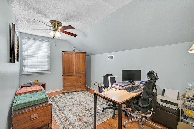 office with ceiling fan, light hardwood / wood-style floors, a textured ceiling, and vaulted ceiling