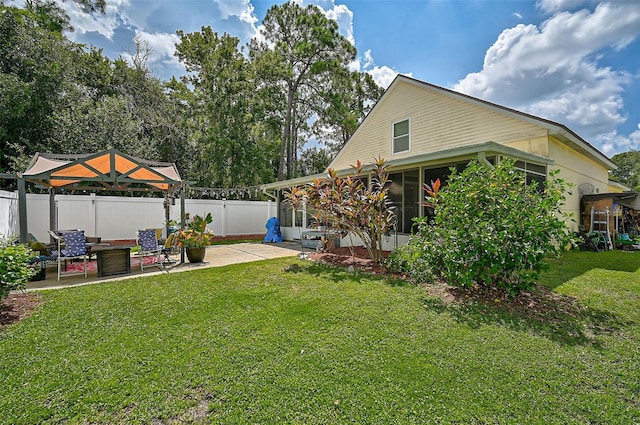 view of yard featuring a gazebo, a sunroom, and a patio