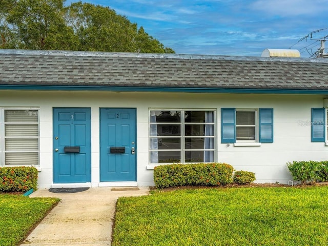 entrance to property featuring a yard