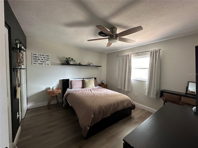 bedroom with ceiling fan, a textured ceiling, and hardwood / wood-style flooring