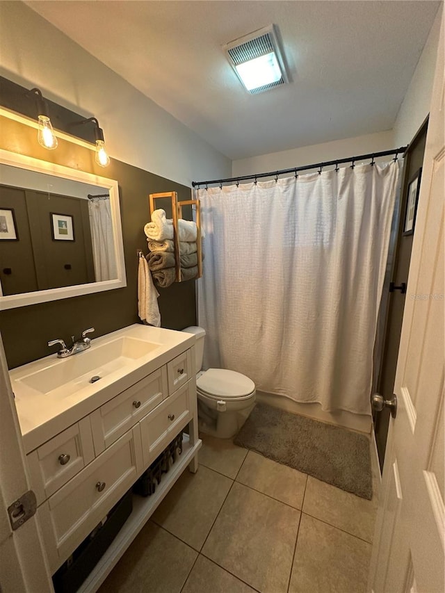 bathroom with vanity, toilet, and tile patterned flooring