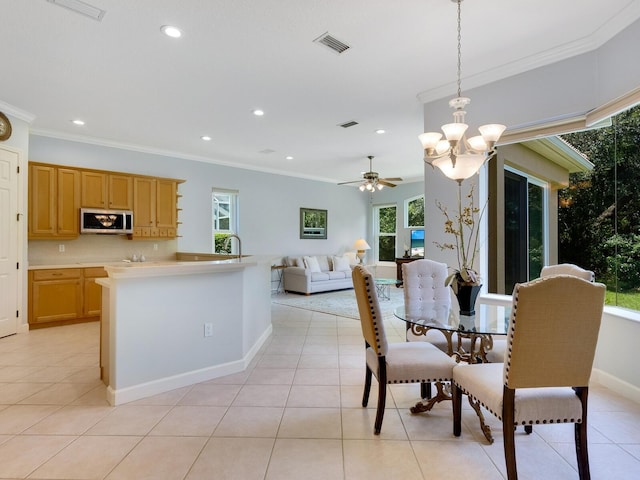 dining area with light tile patterned floors, recessed lighting, visible vents, and ornamental molding