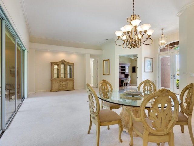 dining area featuring ornamental molding, light colored carpet, a notable chandelier, and french doors