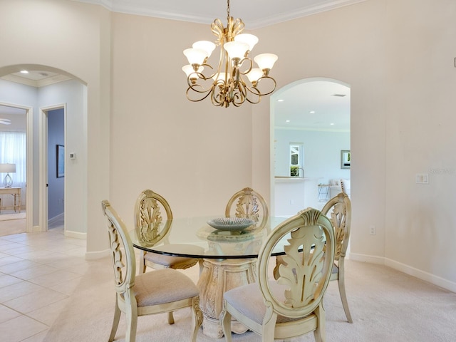 dining room featuring baseboards, arched walkways, and ornamental molding