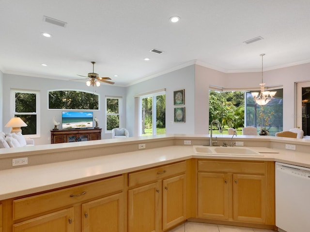 kitchen featuring dishwasher, light countertops, a sink, and visible vents