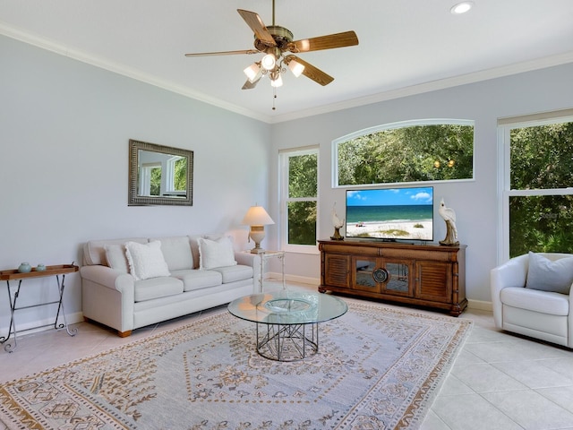 living area featuring ornamental molding, light tile patterned flooring, baseboards, and a ceiling fan