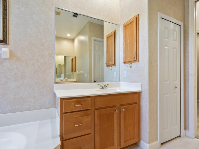 full bathroom with tile patterned floors, a closet, and vanity