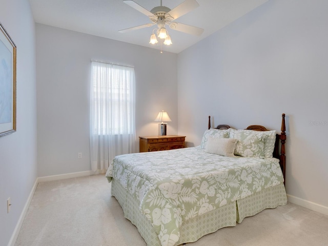 bedroom featuring baseboards, ceiling fan, and light colored carpet