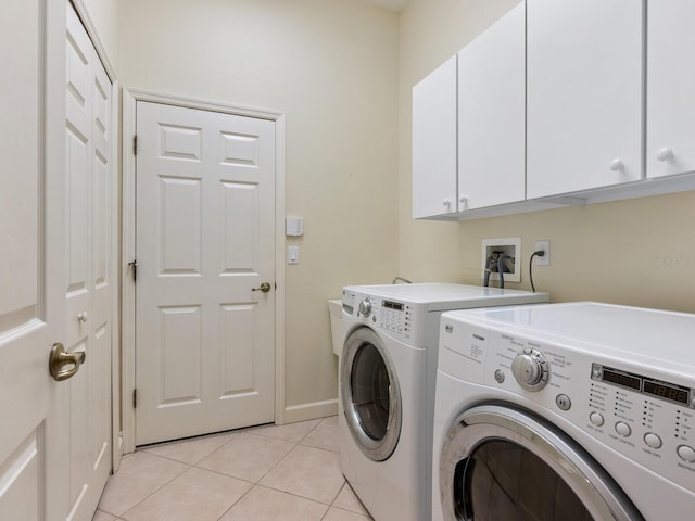 laundry room featuring cabinet space, washing machine and clothes dryer, and light tile patterned floors