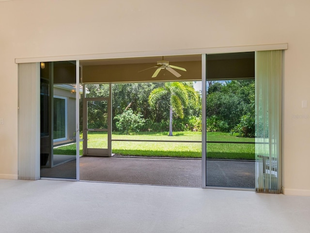 entryway with a healthy amount of sunlight, carpet, and ceiling fan