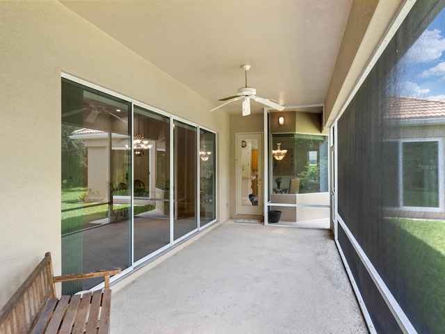 unfurnished sunroom with a ceiling fan