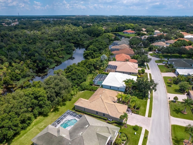 bird's eye view featuring a water view and a wooded view