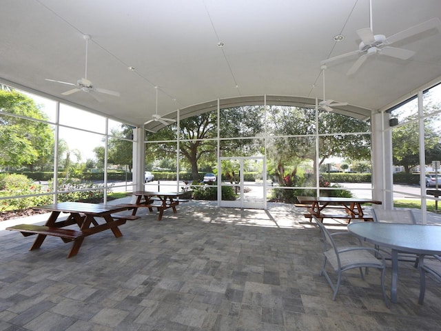 sunroom / solarium with vaulted ceiling and a ceiling fan