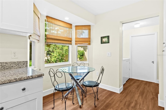 dining room with washer / dryer and hardwood / wood-style flooring