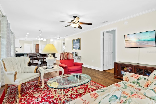 living room with ceiling fan, ornamental molding, and dark hardwood / wood-style floors