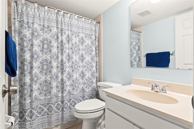 bathroom with tile patterned floors, vanity, and toilet