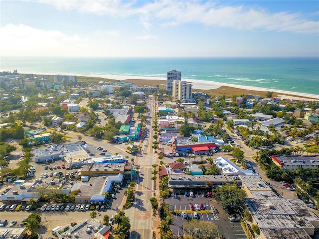 birds eye view of property with a water view and a view of the beach