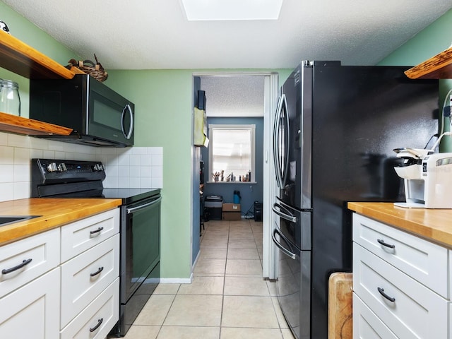 kitchen with white cabinetry, black appliances, tasteful backsplash, and a textured ceiling