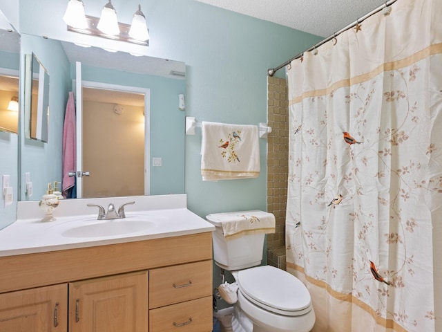 bathroom featuring curtained shower, toilet, a textured ceiling, and vanity