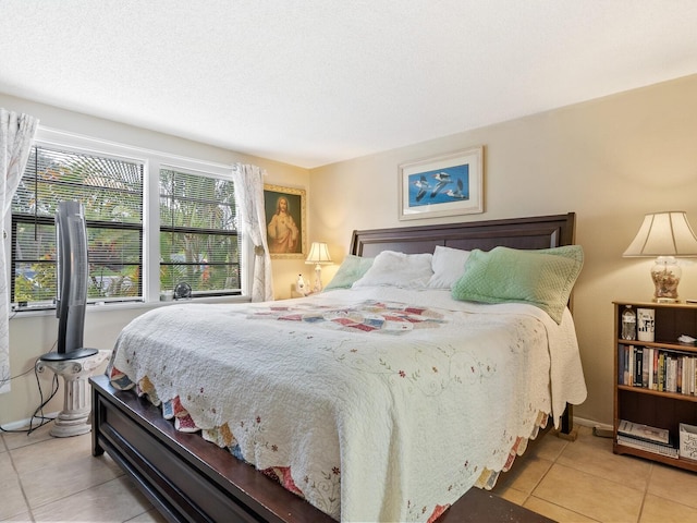 bedroom with a textured ceiling and light tile patterned floors