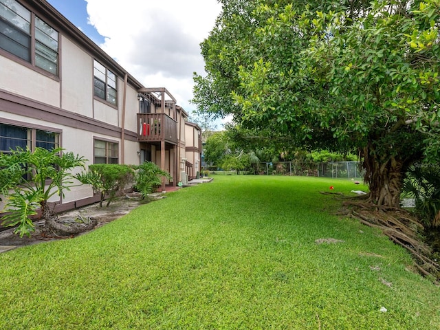 view of yard with a balcony