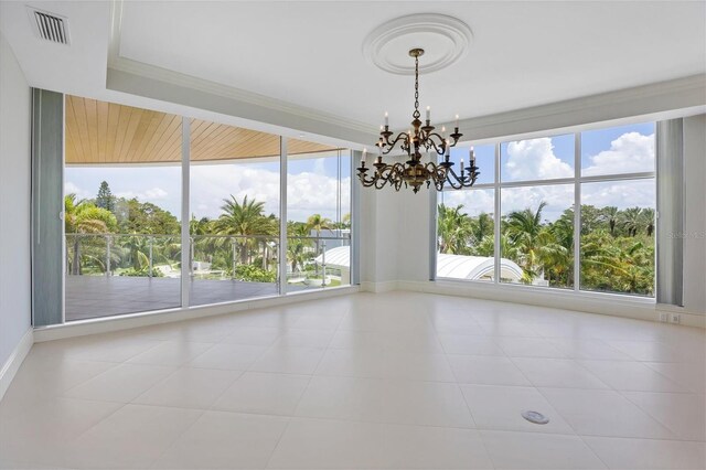 unfurnished room featuring tile patterned floors and a chandelier